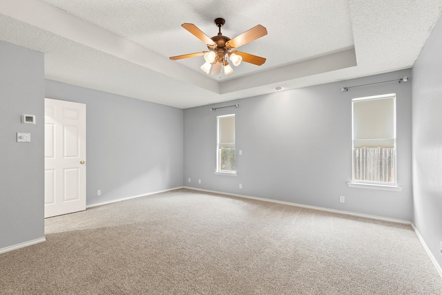 3402 Alicia Ct, Midland, TX 79707 - empty room featuring carpet, a raised ceiling, ceiling fan, and a textured ceiling