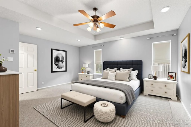 3402 Alicia Ct, Midland, TX 79707 - bedroom featuring light carpet, a tray ceiling, recessed lighting, and a ceiling fan