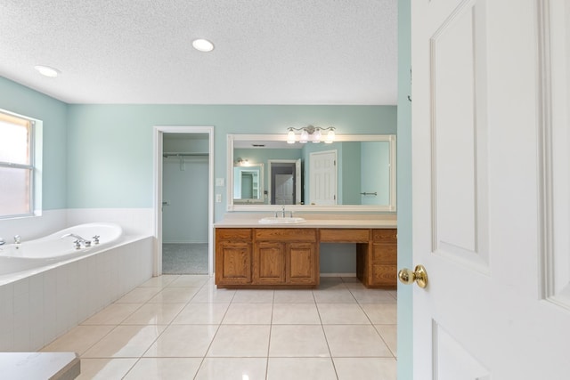3402 Alicia Ct, Midland, TX 79707 - bathroom featuring vanity, a garden tub, a textured ceiling, and tile patterned floors