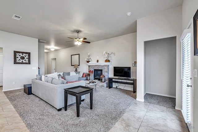 tiled living room featuring ceiling fan