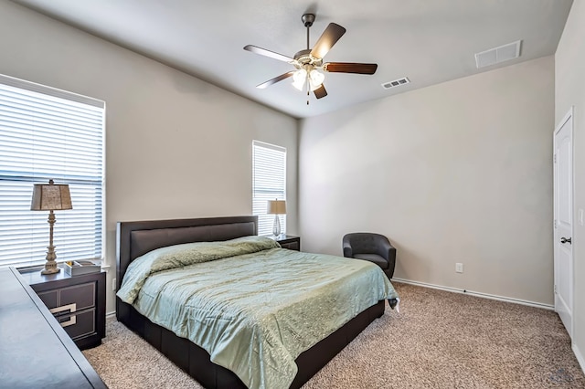 bedroom featuring light colored carpet and ceiling fan