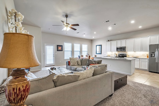 tiled living room featuring ceiling fan