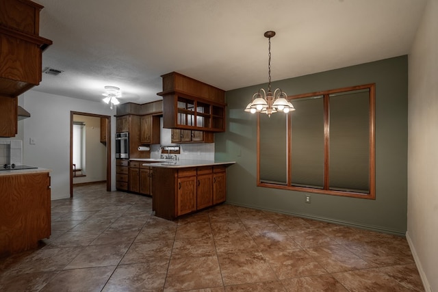 kitchen featuring open shelves, visible vents, light countertops, a peninsula, and stainless steel oven