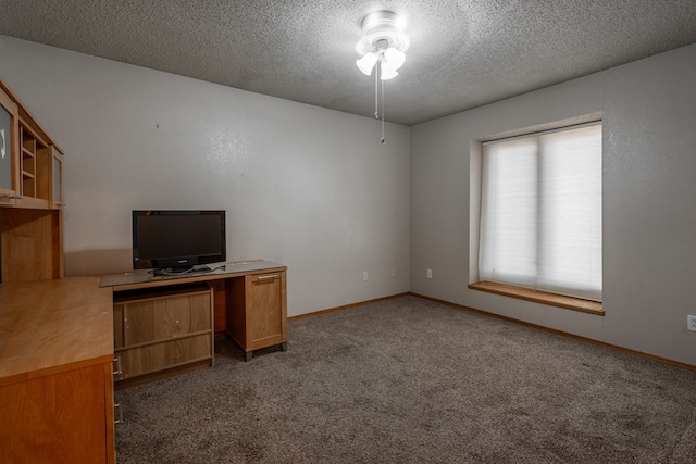 unfurnished office featuring a ceiling fan, carpet flooring, a textured ceiling, and baseboards
