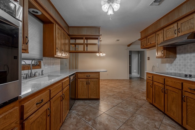 kitchen with tasteful backsplash, brown cabinets, stainless steel dishwasher, a sink, and under cabinet range hood