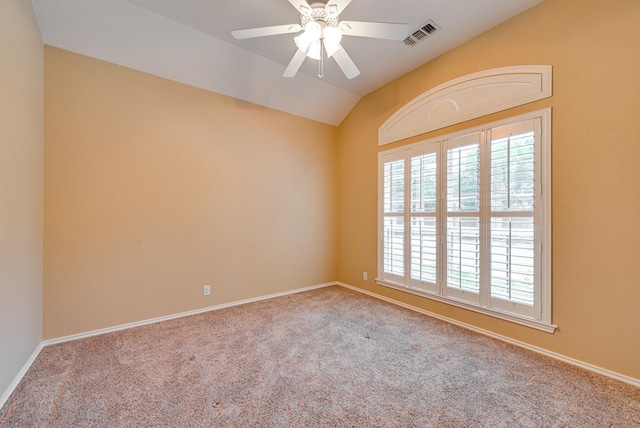 unfurnished room featuring a ceiling fan, carpet flooring, vaulted ceiling, and baseboards