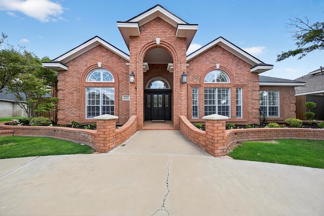 5703 Devlin Pl, Midland, TX 79707 - view of front of home with brick siding and a front lawn