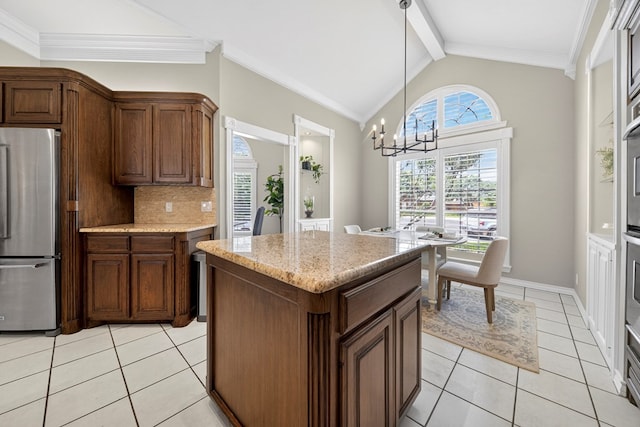 5703 Devlin Pl, Midland, TX 79707 - kitchen with freestanding refrigerator, light tile patterned floors, backsplash, a chandelier, and hanging light fixtures