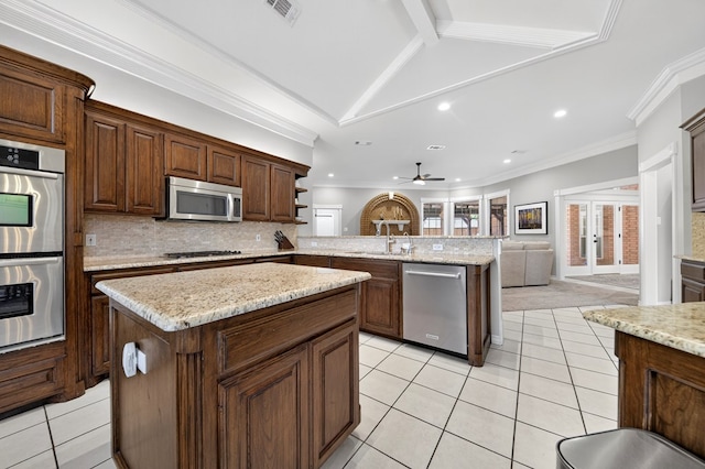 5703 Devlin Pl, Midland, TX 79707 - kitchen featuring stainless steel appliances, a peninsula, light tile patterned floors, recessed lighting, and backsplash