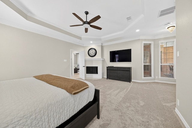 5703 Devlin Pl, Midland, TX 79707 - bedroom with a tray ceiling, crown molding, recessed lighting, light carpet, and a fireplace