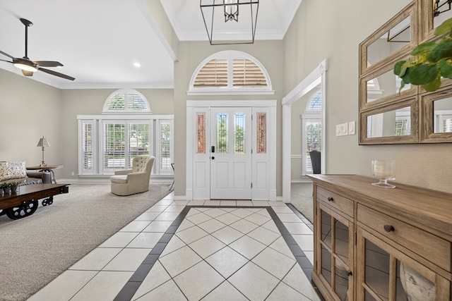 5703 Devlin Pl, Midland, TX 79707 - foyer with light tile patterned flooring, crown molding, a ceiling fan, a high ceiling, and recessed lighting