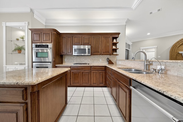 5703 Devlin Pl, Midland, TX 79707 - kitchen with stainless steel appliances, decorative backsplash, light stone countertops, light tile patterned flooring, and ornamental molding