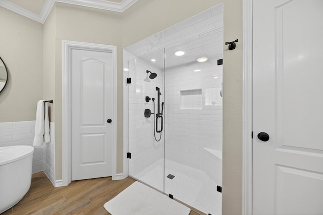 5703 Devlin Pl, Midland, TX 79707 - full bath featuring ornamental molding, wood finished floors, a shower stall, a freestanding tub, and tile walls