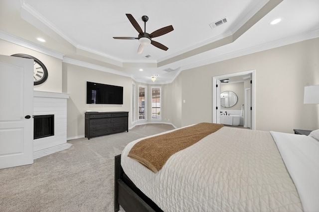 5703 Devlin Pl, Midland, TX 79707 - bedroom featuring crown molding, light carpet, a tray ceiling, recessed lighting, and a fireplace with flush hearth
