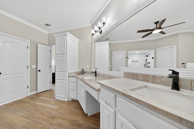 5703 Devlin Pl, Midland, TX 79707 - bathroom featuring double vanity, a ceiling fan, ornamental molding, wood finished floors, and a shower
