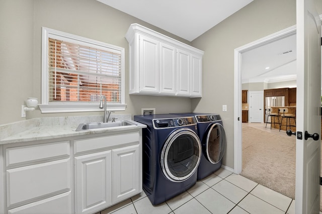 5703 Devlin Pl, Midland, TX 79707 - washroom with cabinet space, light colored carpet, washing machine and dryer, and light tile patterned flooring