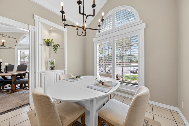 5703 Devlin Pl, Midland, TX 79707 - dining space with a chandelier, ornamental molding, light tile patterned floors, and a towering ceiling