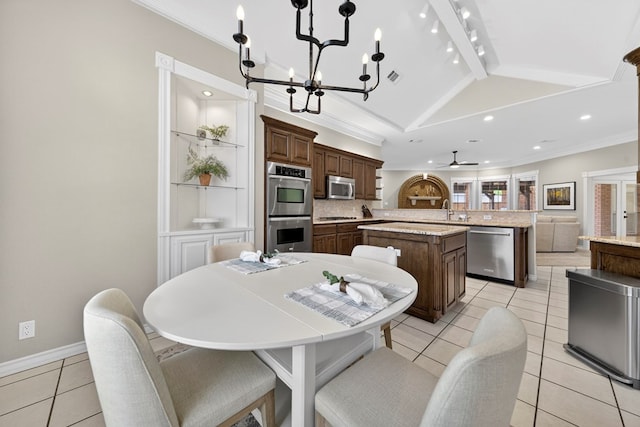 5703 Devlin Pl, Midland, TX 79707 - kitchen featuring appliances with stainless steel finishes, a kitchen island, decorative backsplash, light tile patterned floors, and recessed lighting