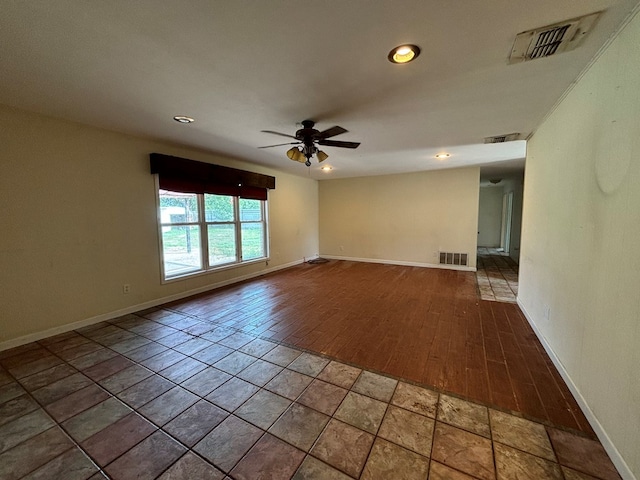 spare room featuring hardwood / wood-style flooring and ceiling fan