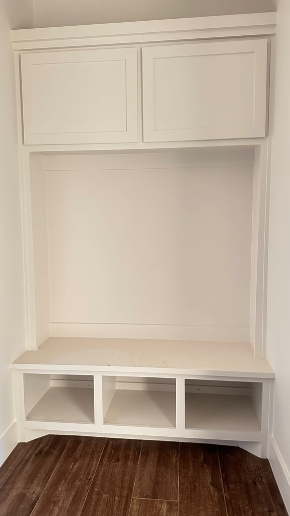 mudroom with dark wood finished floors