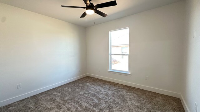 unfurnished room with carpet flooring, a ceiling fan, and baseboards