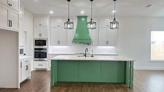 kitchen with tasteful backsplash, visible vents, stainless steel appliances, custom exhaust hood, and white cabinetry