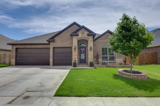 french provincial home featuring brick siding, concrete driveway, a garage, and roof with shingles