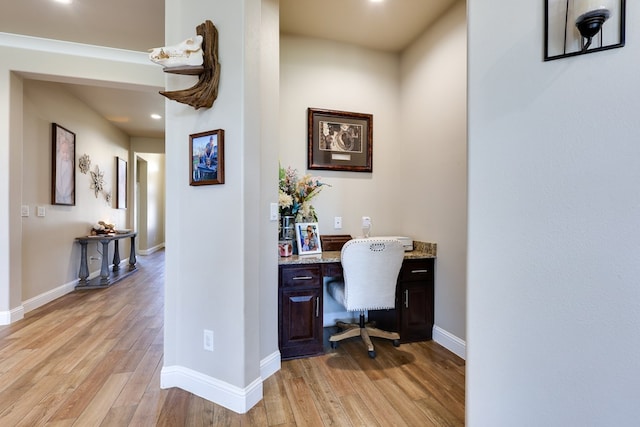home office with built in study area, light wood-style flooring, baseboards, and recessed lighting
