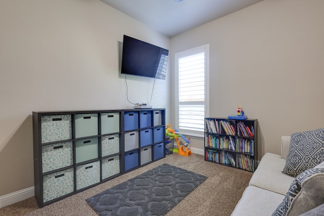 rec room with carpet and baseboards