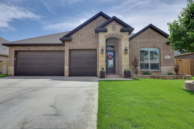 french country style house featuring brick siding, concrete driveway, an attached garage, and a shingled roof