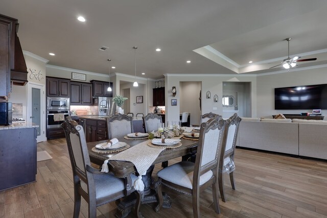 dining space featuring ornamental molding, light wood-type flooring, a ceiling fan, and recessed lighting