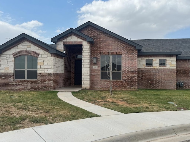 5312 Kilyn Ct, Midland, TX 79703 - view of front facade with a front yard, brick siding, roof with shingles, and stone siding