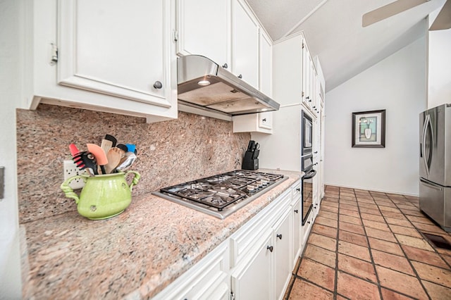 kitchen with white cabinetry, light stone countertops, tasteful backsplash, lofted ceiling, and appliances with stainless steel finishes