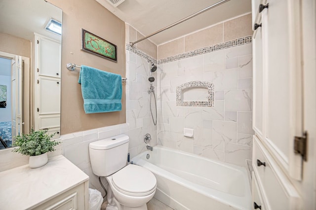 full bathroom featuring toilet, vanity, tile walls, and tiled shower / bath