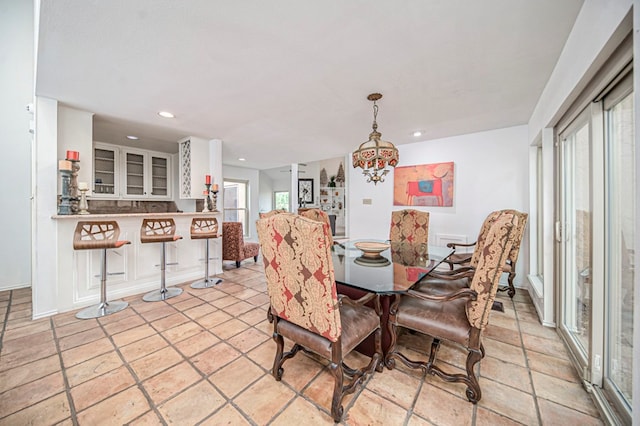 dining space with plenty of natural light and a notable chandelier