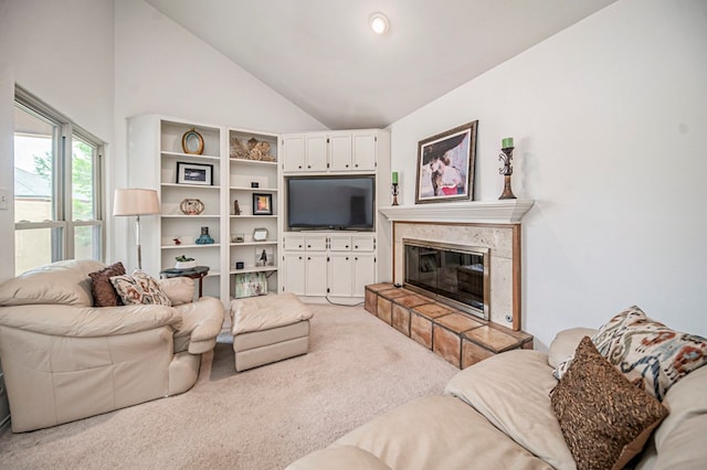 living room featuring carpet, a stone fireplace, and high vaulted ceiling