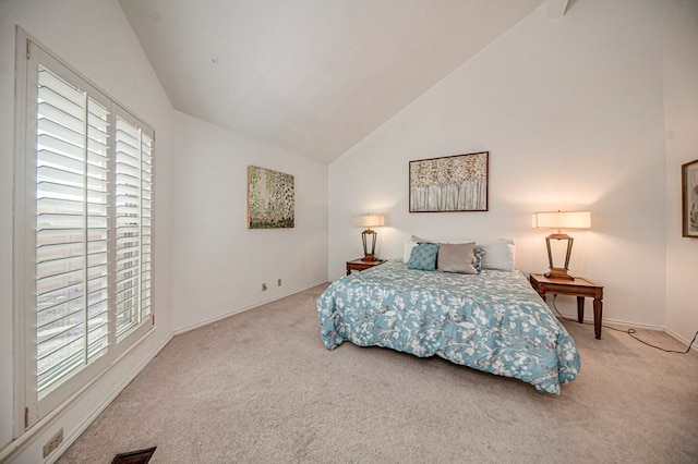 carpeted bedroom featuring high vaulted ceiling and multiple windows