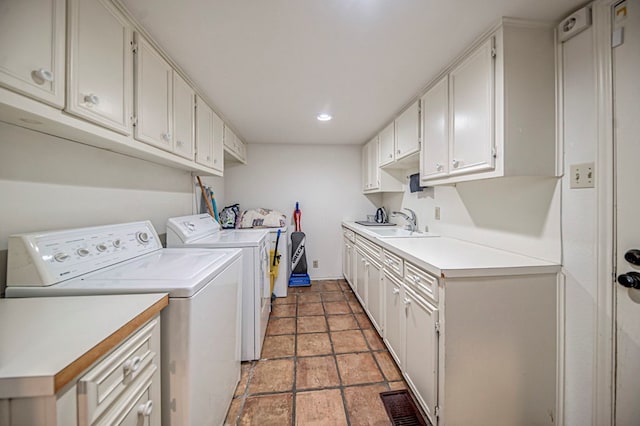 washroom featuring washer and clothes dryer, cabinets, and sink