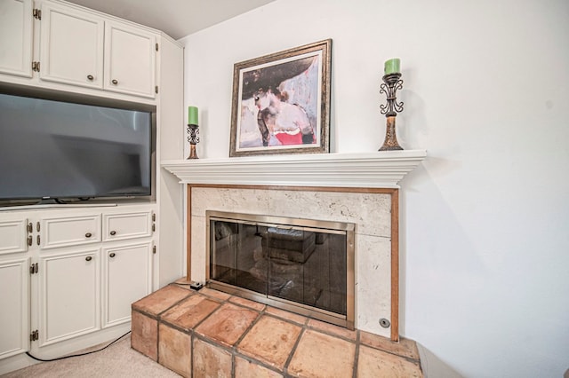 interior space featuring light colored carpet and a high end fireplace