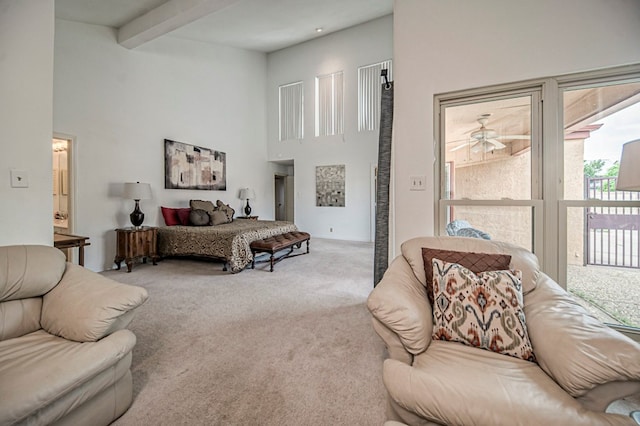 bedroom with beamed ceiling, carpet floors, and a high ceiling