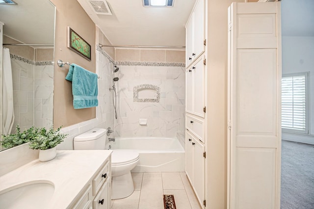 full bathroom with tiled shower / bath combo, tile patterned flooring, a textured ceiling, toilet, and vanity