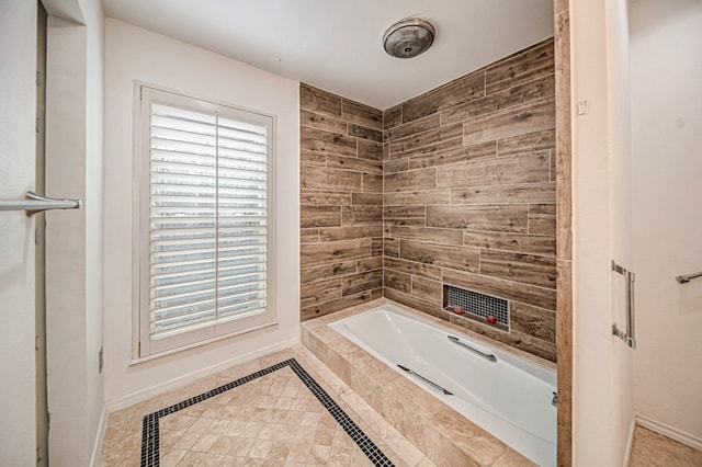 bathroom featuring tile patterned floors and tiled bath