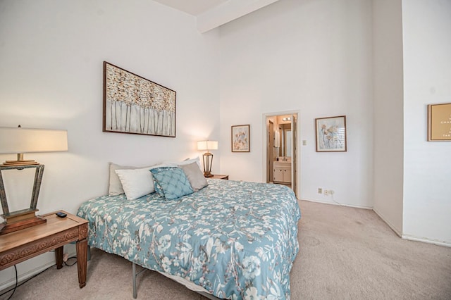 bedroom with light colored carpet and connected bathroom