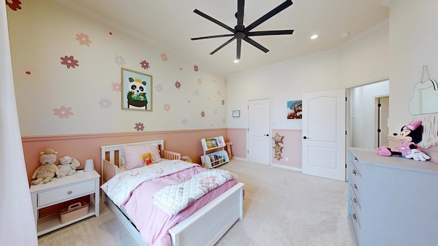 carpeted bedroom featuring ceiling fan and ornamental molding