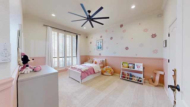 carpeted bedroom with crown molding and ceiling fan