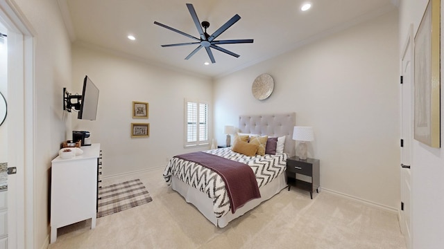 bedroom with ornamental molding, light colored carpet, and ceiling fan