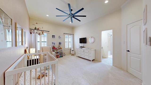 carpeted bedroom with a crib and ornamental molding