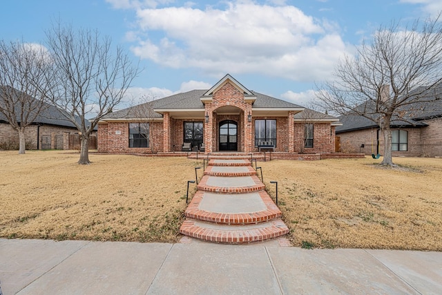 ranch-style house with a front lawn