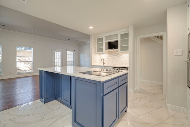 kitchen featuring decorative backsplash, ornamental molding, black electric cooktop, light hardwood / wood-style flooring, and white cabinets