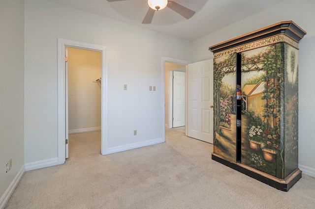 interior space with ceiling fan and light colored carpet